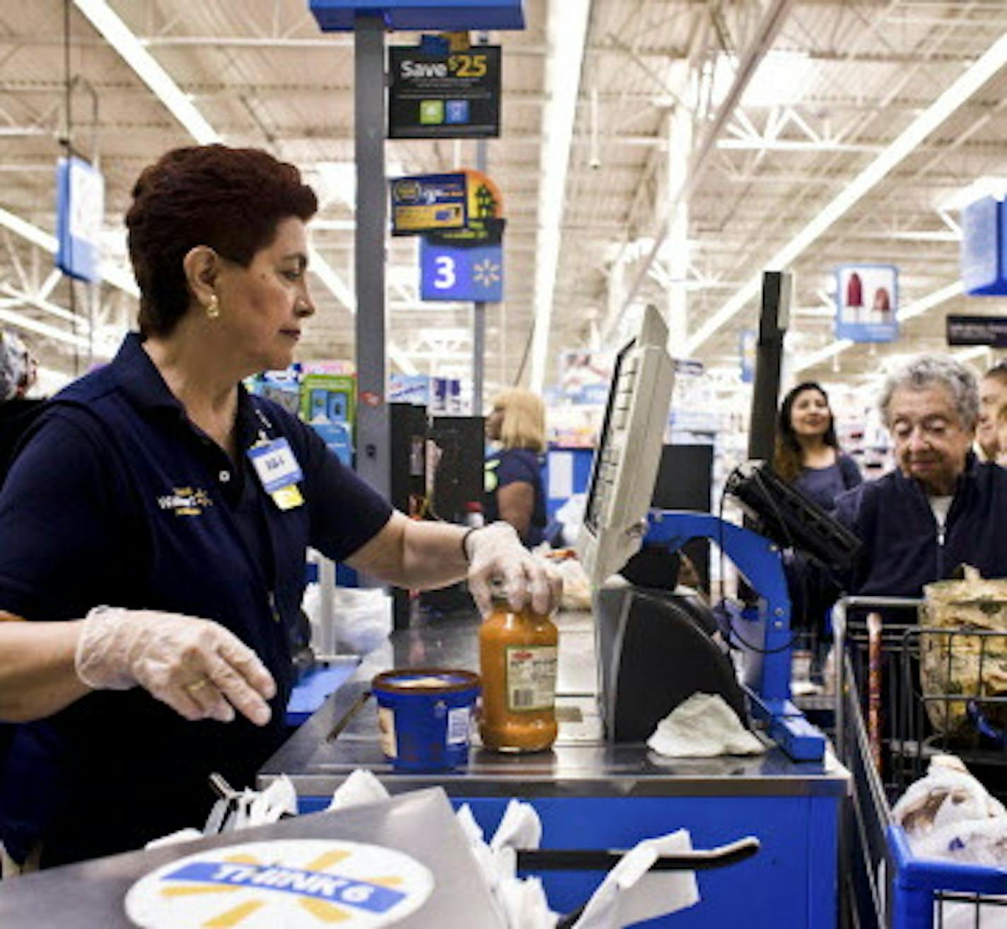 FILE &#xf3; Olga Aguirre checks out a customer at a Walmart Supercenter in North Bergen, N.J., Sept. 23, 2015. When Walmart announced in October that it was significantly increasing its investment in e-commerce, it tacitly acknowledged that it had fallen far behind Amazon in the race for online customers. (Bryan Anselm/The New York Times)