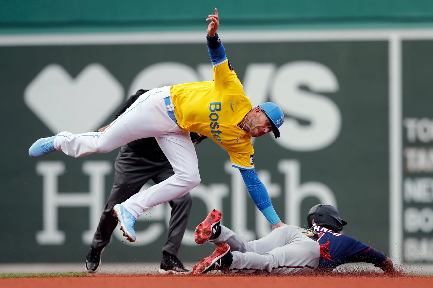 Boston's Trevor Story catches the Twins' Jorge Polanco trying to steal second during the first inning Saturday