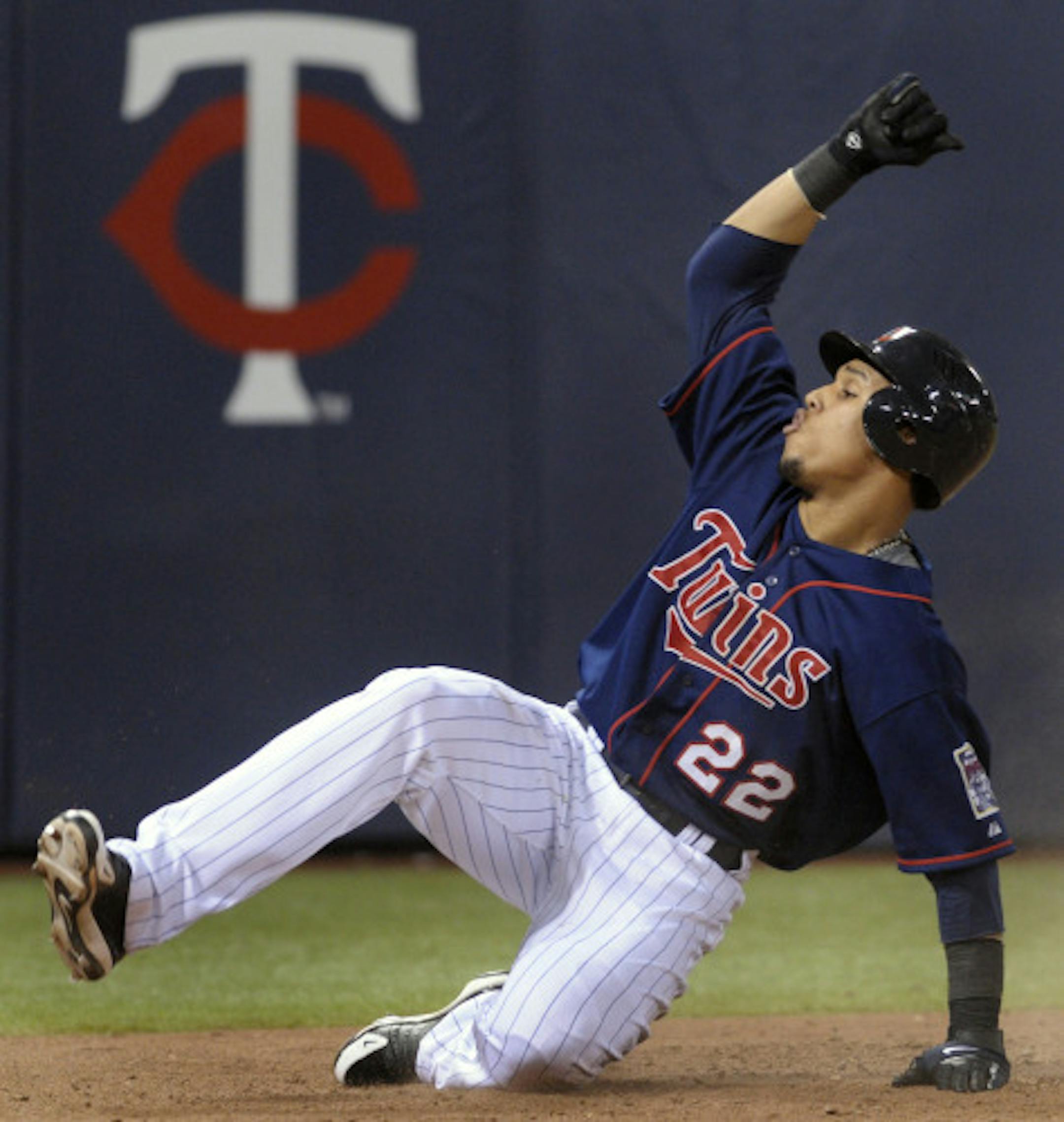 Minnesota Twins' Carlos Gomez reacts as he scores on a double by teammate Alexi Casilla against the Cleveland Indians during the sixth inning of a baseball game on Saturday, July 5, 2008 in Minneapolis.