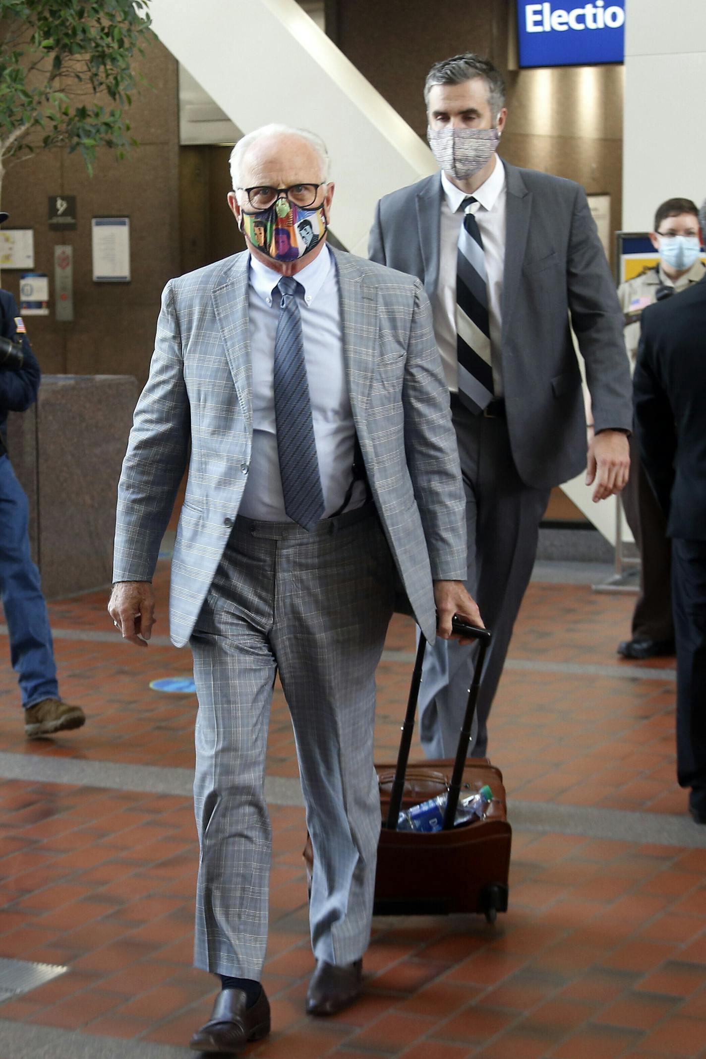 Former Minneapolis Police Officer Thomas Lane, right, enters the Hennepin County Government Center on Tuesday, July 21, 2020, in Minneapolis with his attorney, Earl Gray, front, for a hearing. Lane is one of four former officers charged in the death of George Floyd. (AP Photo/Jim Mone)