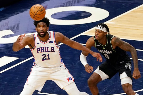 Philadelphia 76ers' Joel Embiid waits for a pass as the Timberwolves' Jarred Vanderbilt defends during the first half