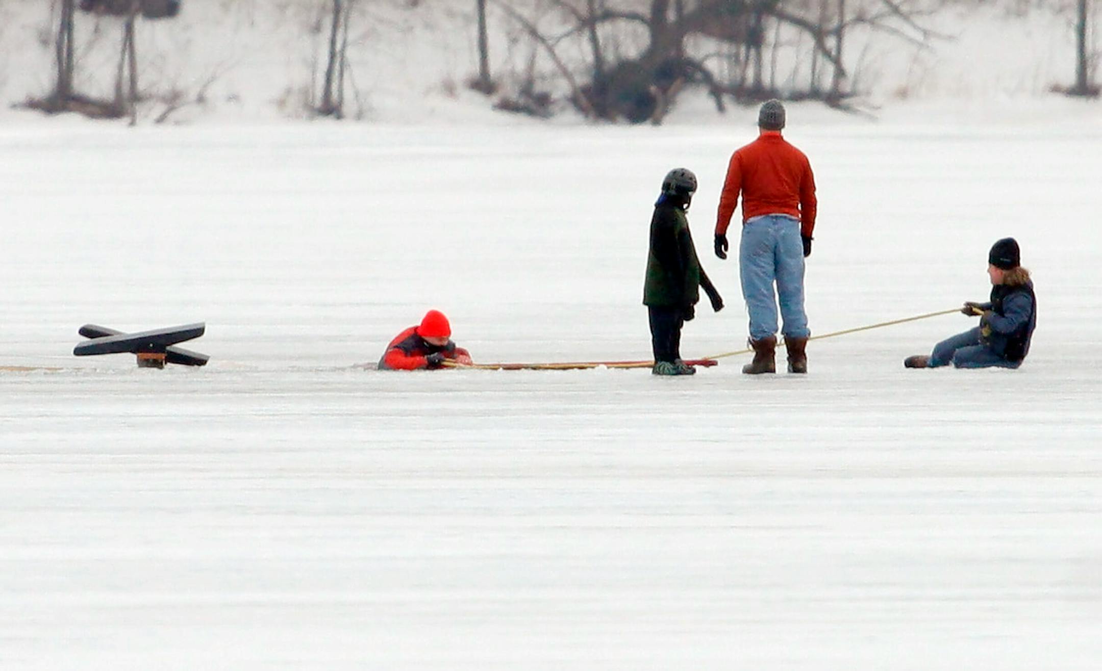 Matthew Kunkel pulled a man out of Lake Harriet as Nathan Caskey and the man's son watched from a distance.