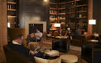 The lobby of the Hewing Hotel was a cozy place to curl up with a book Sunday afternoon. Matt Sharkey-Smith, center, lives in the neighborhood, but was