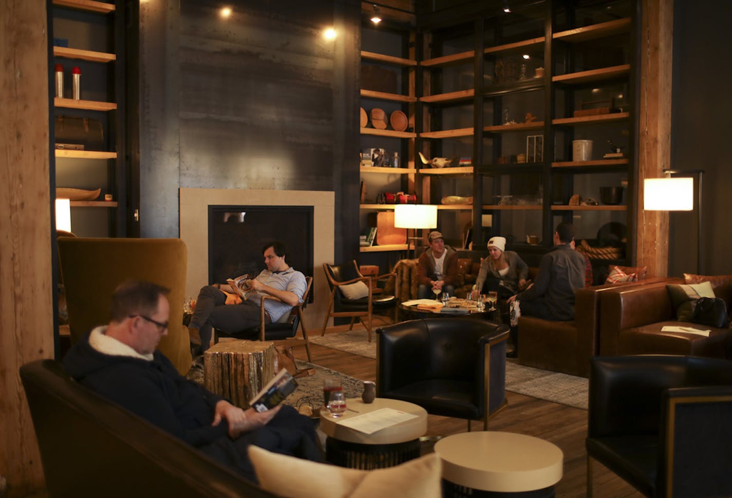 The lobby of the Hewing Hotel was a cozy place to curl up with a book Sunday afternoon. Matt Sharkey-Smith, center, lives in the neighborhood, but was relaxing with his wife and dog and a book in the lobby Sunday afternoon. ] JEFF WHEELER &#x2022; jeff.wheeler@startribune.com The new Hewing Hotel in Minneapolis' North Loop is already popular with locals who want to experience their home town like a tourist. Sunday afternoon, February 12, 2017 was perhaps typical, with many locals enjoying the lo