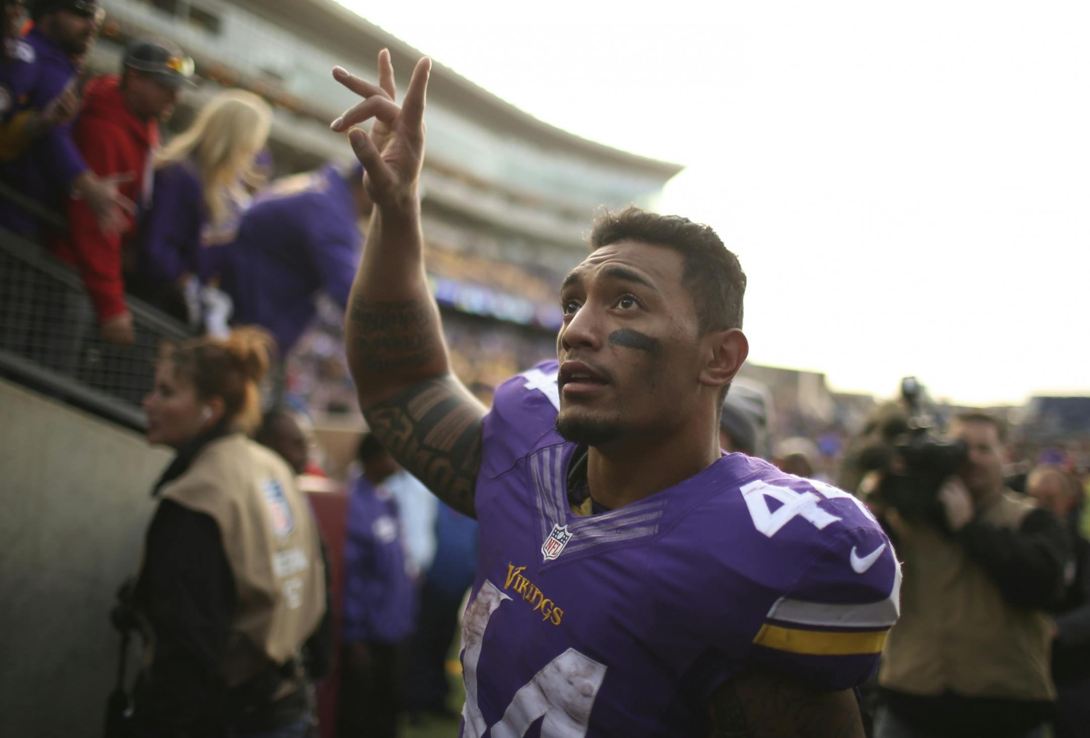Minnesota Vikings running back Matt Asiata (44) waved to fans as he walked off the field after his three touchdown performance Sunday at TCF Bank Stadium.