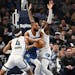 Timberwolves center Rudy Gobert is defended by Grizzlies guard Jordan Goodwin (4) and forward Jaren Jackson Jr. during the first half of the Wolves' 1