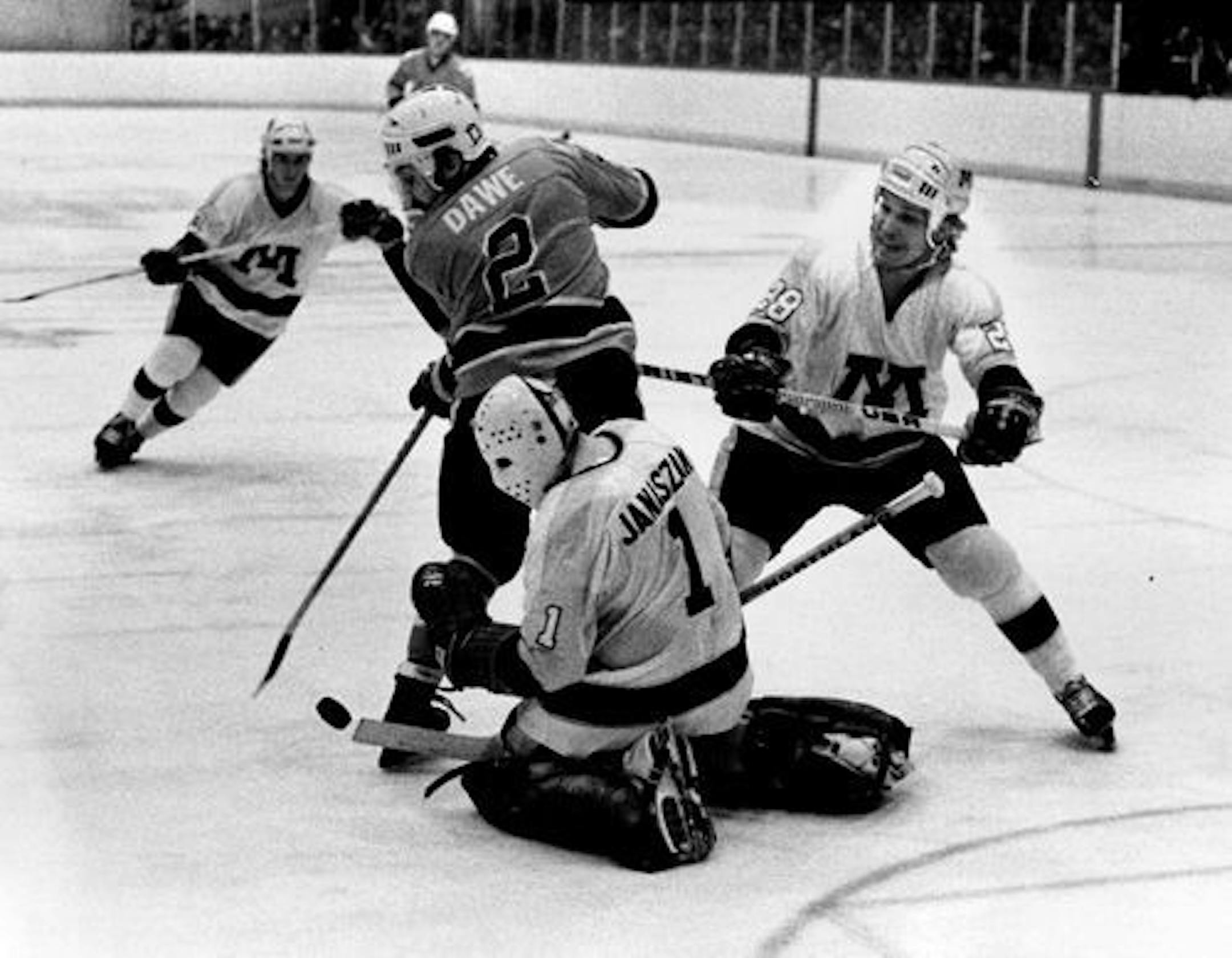 March 19, 1979 Gopher goalie Steve Janaszak deflected puck. No.2 of Bowling Green is Steve Dawe William Seaman, Minneapolis Star Tribune