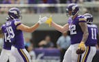Vikings wide receiver Adam Thielen (19) congratulated Vikings tight end Kyle Rudolph (82) after his 27 yard catch and touchdown in the second quarter.
