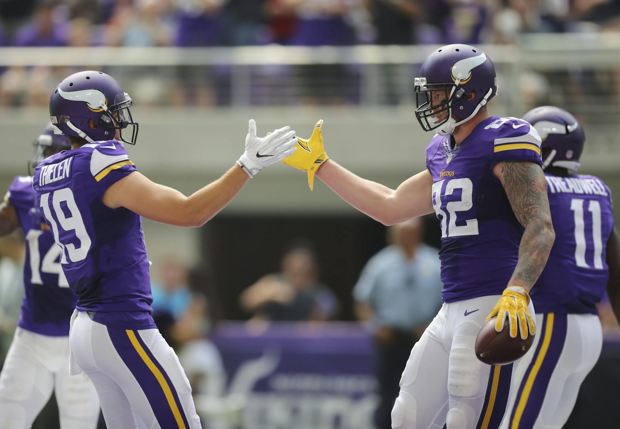 Vikings wide receiver Adam Thielen (19) congratulated Vikings tight end Kyle Rudolph (82) after his 27 yard catch and touchdown in the second quarter.