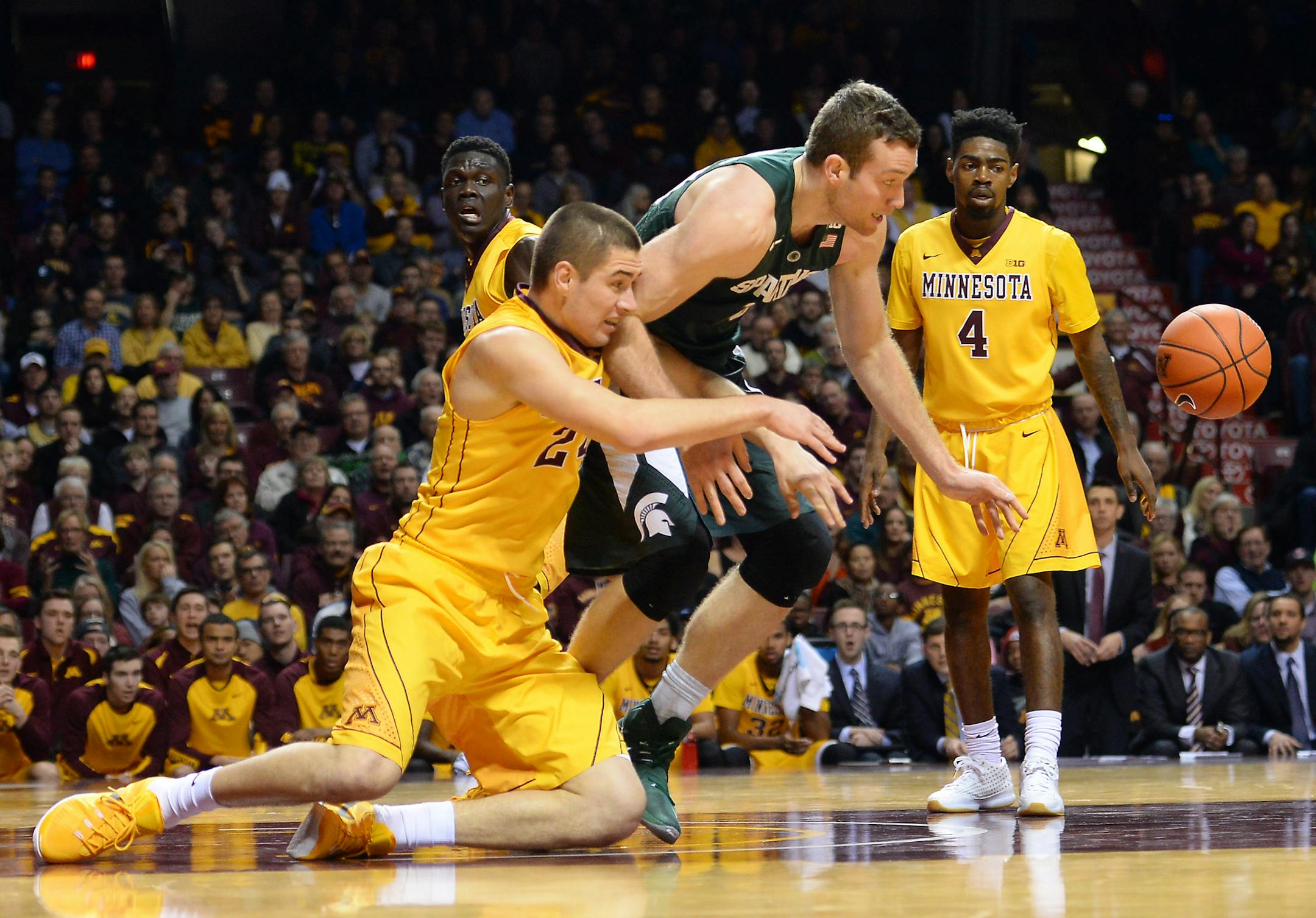 Minnesota Golden Gophers forward Joey King (24) and Michigan State Spartans forward Matt Costello (10) chased after a loose ball in the first half Saturday. ] (AARON LAVINSKY/STAR TRIBUNE) aaron.lavinsky@startribune.com The University of Minnesota Golden Gophers men's basketball team played the Michigan State Spartans on Saturday, Jan. 2, 2016 at Williams Arena in Minneapolis, Minn.