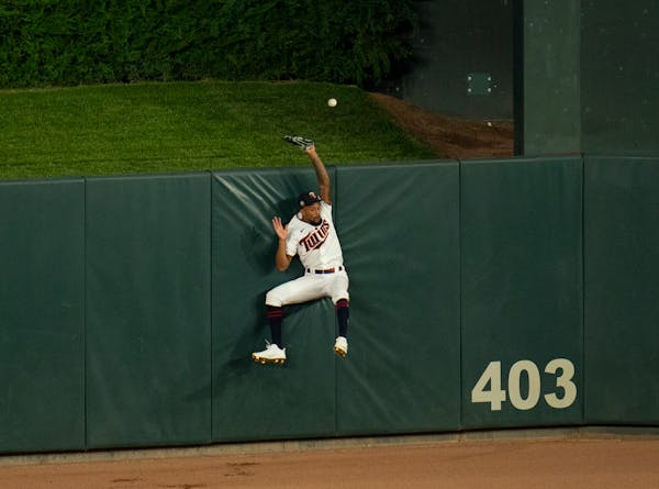 Twins center fielder Byron Buxton leapt for a ball hit by Cardinals shortstop Tommy Edman that proved to be a home run in the eighth inning.