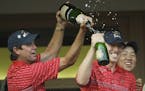 United States team captain Paul Azinger, left, poured champagne on Hunter Mahan after winning the Ryder Cup golf tournament at the Valhalla Golf Club 