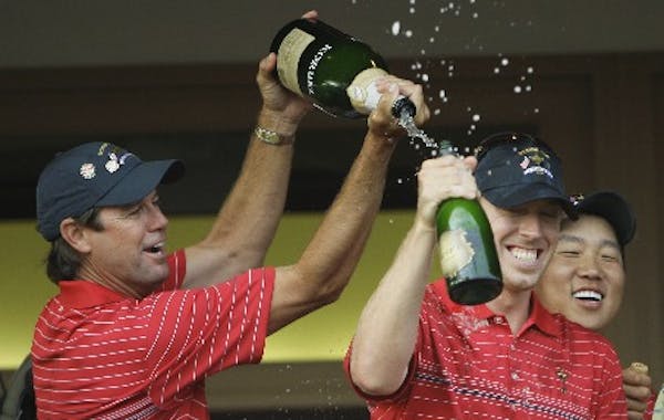 United States team captain Paul Azinger, left, poured champagne on Hunter Mahan after winning the Ryder Cup golf tournament at the Valhalla Golf Club 