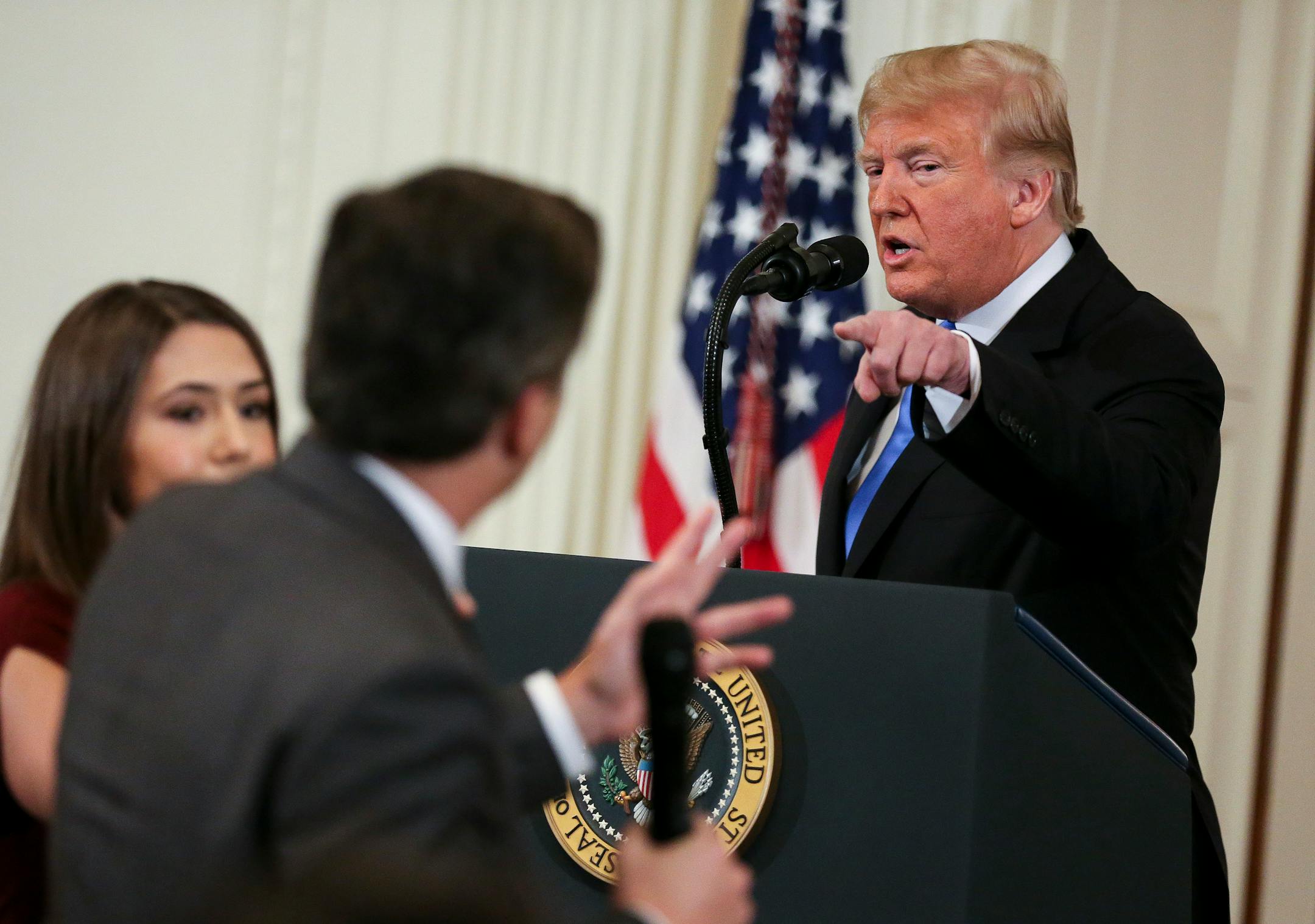 A White House staff member, left, tries to take away the microphone from CNN White House correspondent Jim Acosta during an exchange with President Donald Trump on Wednesday, Nov. 7, 2018, in Washington, D.C. (Oliver Contreras/Sipa USA/TNS) ORG XMIT: 1244990