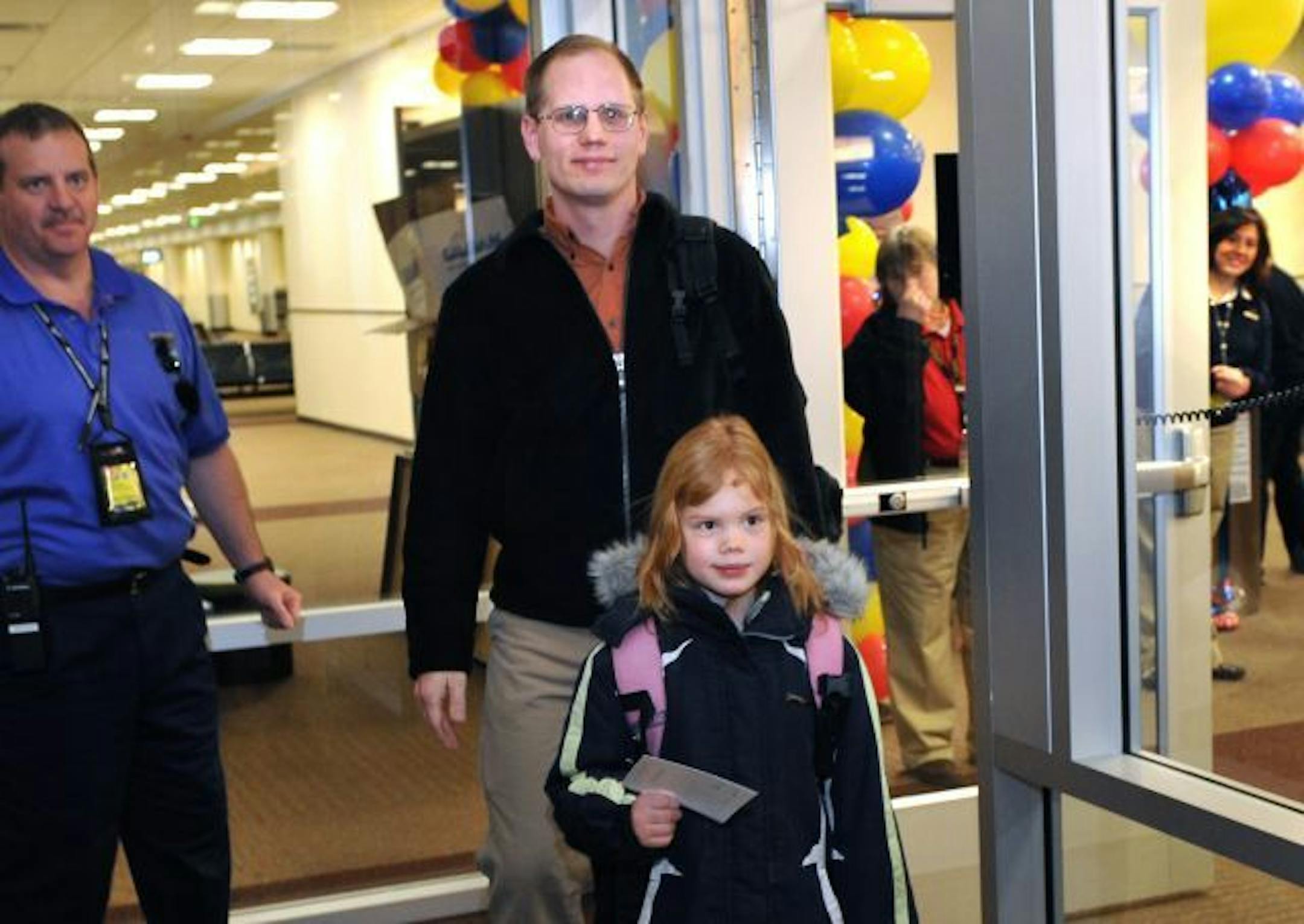 John Zimmerman and his daughter Jenna, 7, of Bloomington, were the first passengers to board Southwest Airlines flight 780 Sunday morning.