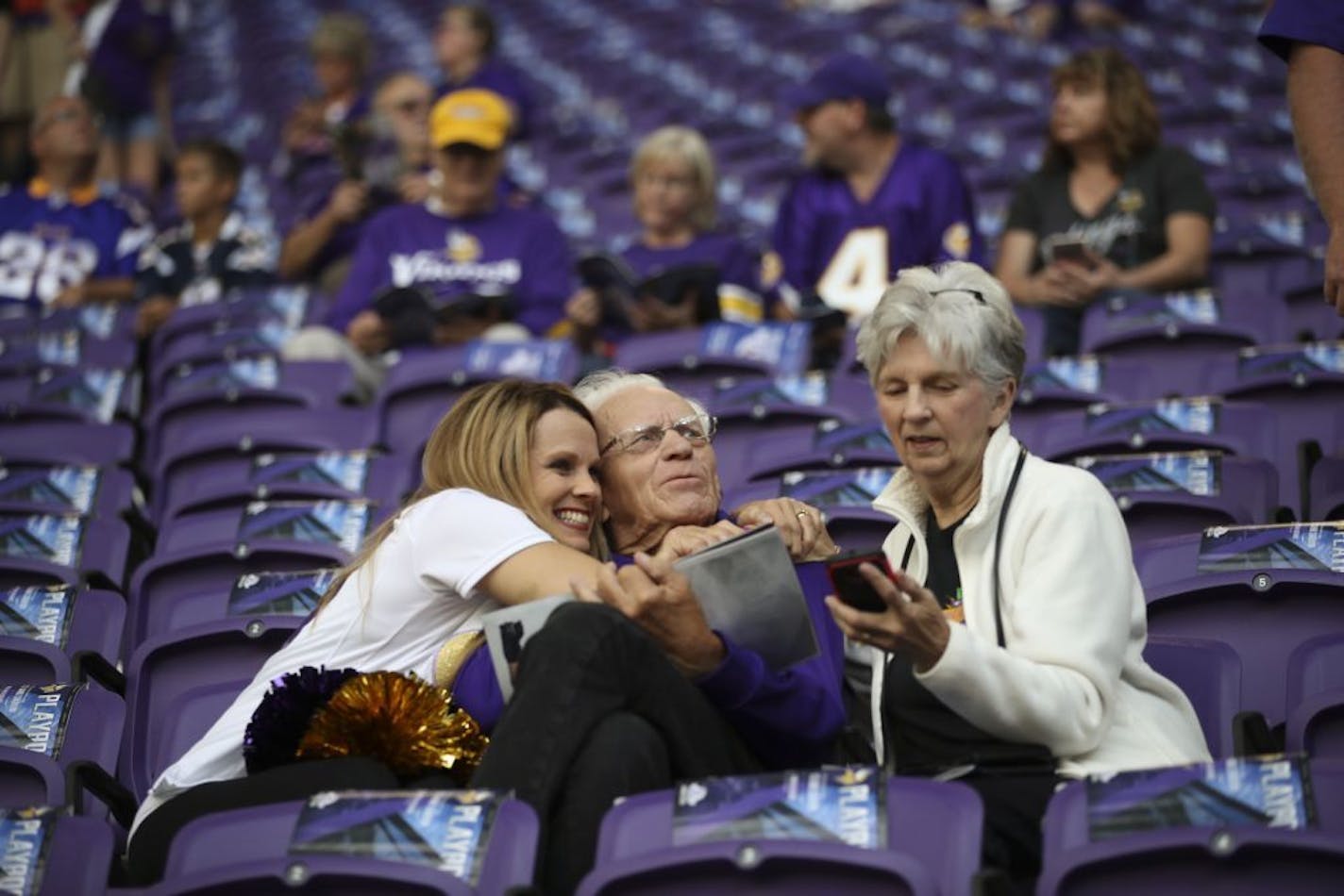 Rebecca Nelson hugged her dad, Ray Renstrom, while visiting with him and her mom, Lila, in the stands before the kickoff. A Vikings cheerleader from 1997-99, she was going to join other alumni on the field later.