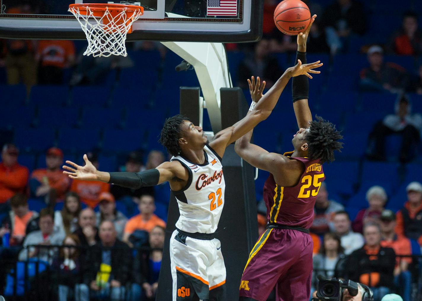 Gophers center Daniel Oturu shoots over Oklahoma State forward Kalib Boone in Tulsa, Okla.