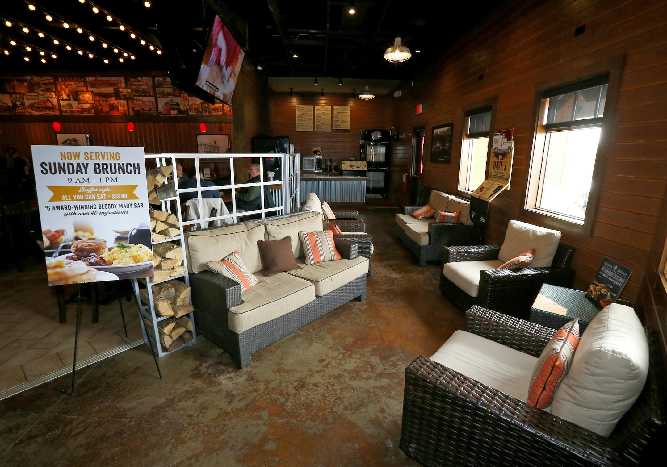 The new main entrance decorated with outside patio furniture at the newly remodeled Famous Dave's Legendary Pit Bar-B-Que restaurant on Wednesday, March 4, 2015, in Bolingbrook, Illinois, (AP Photo/Jeff Haynes) ORG XMIT: ILJH107