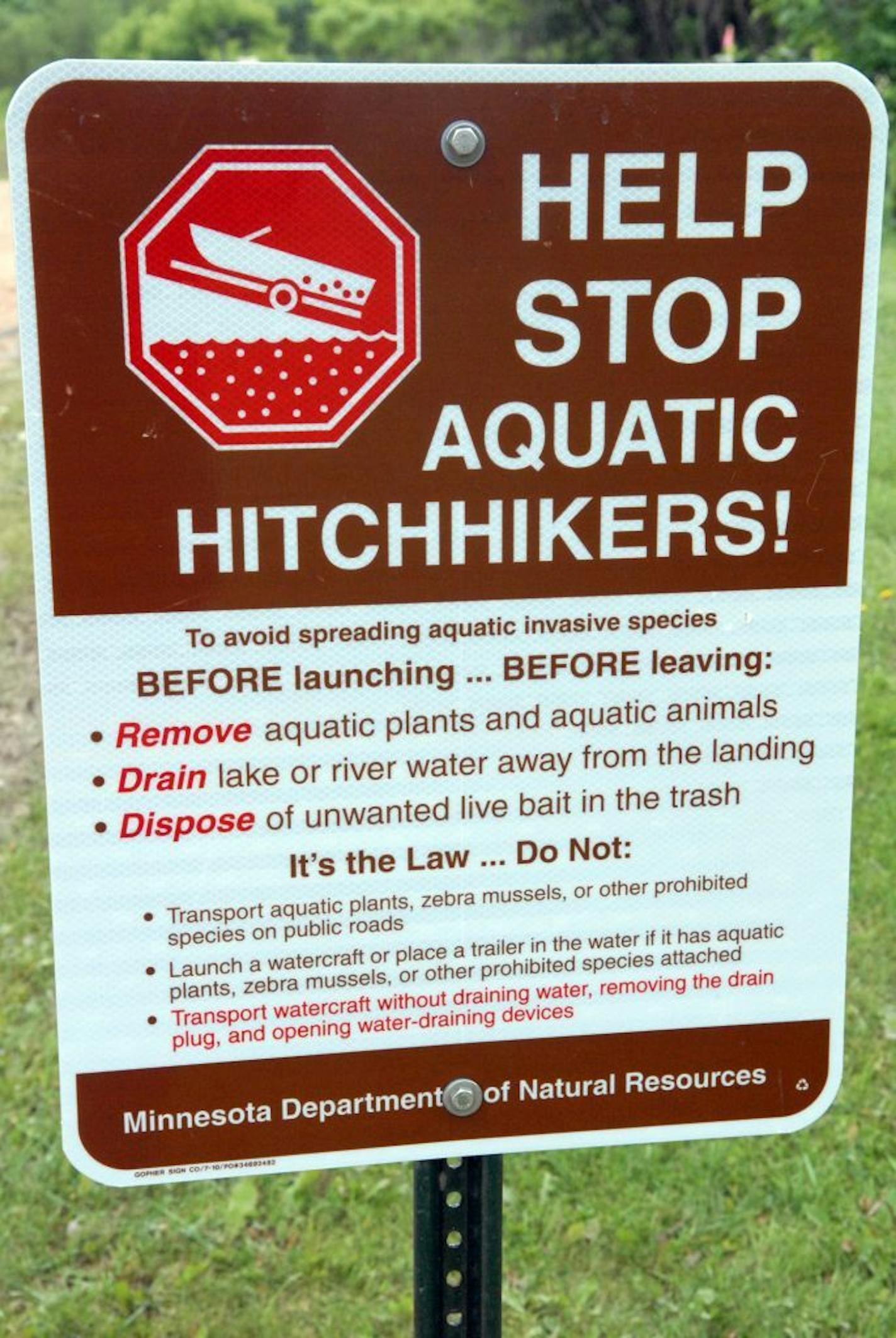 Several signs advising watercraft owners about transporting aquatic invasive species often are placed at public launch sites