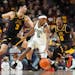 Michigan State guard Tre Holloman (5) is defended by Minnesota forward Dawson Garcia (3) and guard Elijah Hawkins (0) during the first half of an NCAA