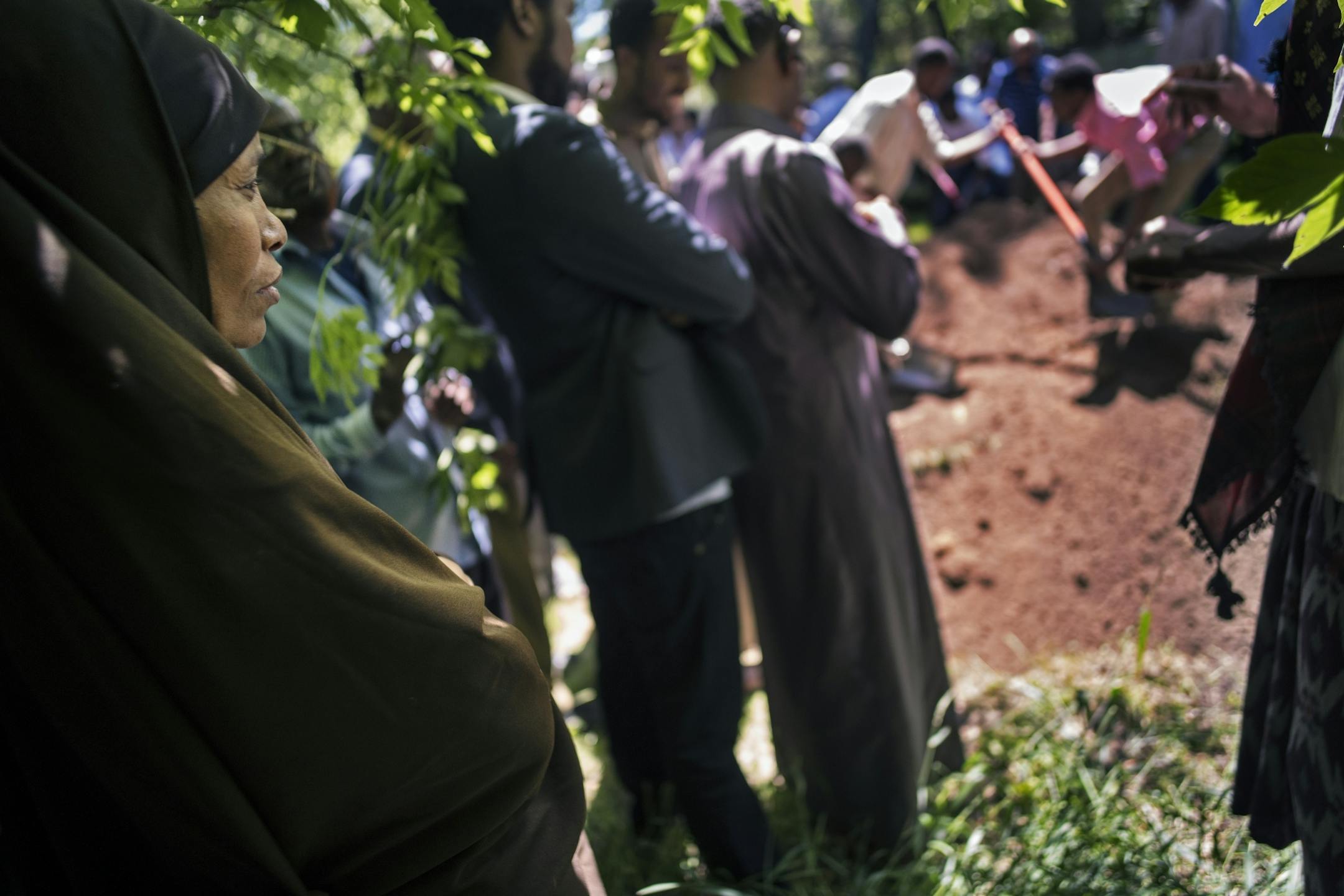Lul Mohamed watched from the edges as men buried her son Ahmed Ashi according to Islamic custom. [In Willmar where Ahmed Ashi, 11 who drowned along with childhood friend Idris Hussein,11, the community came together to lay the boys to rest.Richard Tsong-Taatarii/rtsong-taatarii@startribune.com
