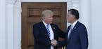 President-elect Donald Trump and Mitt Romney shake hands as Romney leaves Trump National Golf Club Bedminster in Bedminster, N.J., Saturday, Nov. 19, 