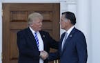 President-elect Donald Trump and Mitt Romney shake hands as Romney leaves Trump National Golf Club Bedminster in Bedminster, N.J., Saturday, Nov. 19, 