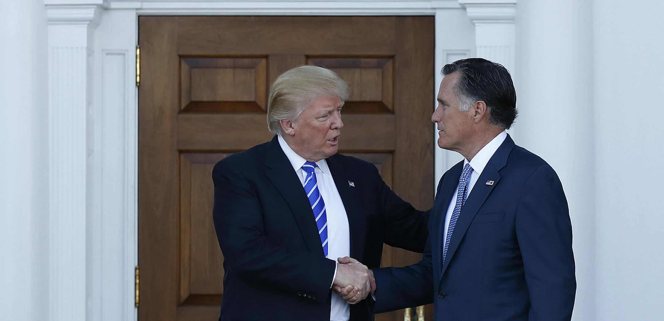 President-elect Donald Trump and Mitt Romney shake hands as Romney leaves Trump National Golf Club Bedminster in Bedminster, N.J., Saturday, Nov. 19, 2016.
