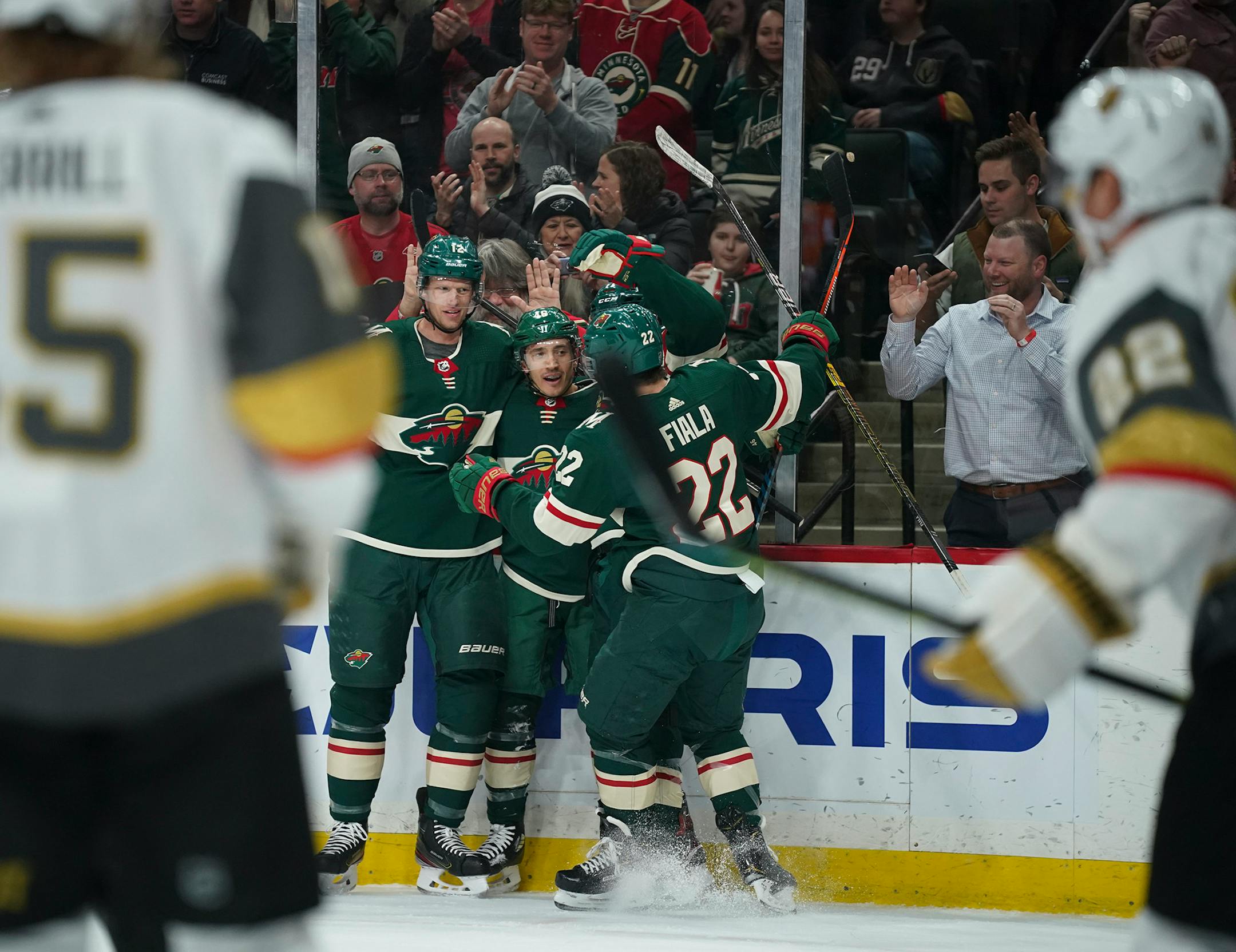 Wild defenseman Jared Spurgeon (46) celebrates his second period goal with teammates Eric Staal (12) and Kevin Fiala (22)