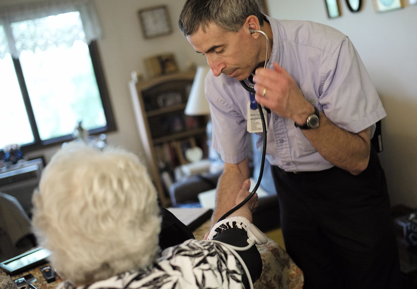 At her home in New Brighton, Allina paramedic John O'Brien an 84-year old patient named Darlene with COPD who has recently recovered from an infection. ]rtsong-taatarii@startribune.com