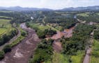 An aerial view shows flooding triggered by a dam collapse near Brumadinho, Brazil, Friday, Jan. 25, 2019. Brazilian mining company Vale SA said it did