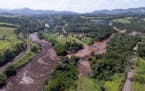 An aerial view shows flooding triggered by a dam collapse near Brumadinho, Brazil, Friday, Jan. 25, 2019. Brazilian mining company Vale SA said it did