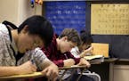 Sophomore Xavier Mansfield, center, 16, works on writing skills during Japanese III class at Patrick Henry High School in Minneapolis on Friday, Decem