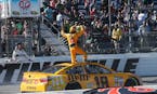 Kyle Busch stood on his car and waved to the crowd as he celebrated winning the Sprint Cup race at Martinsville Speedway