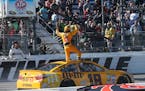 Kyle Busch stood on his car and waved to the crowd as he celebrated winning the Sprint Cup race at Martinsville Speedway