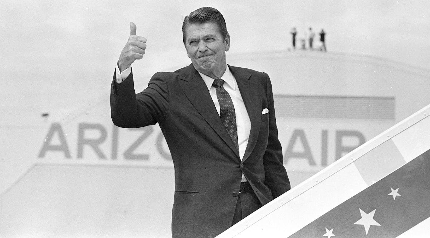 U.S. President Ronald Reagan gives a thumbs-up to reporters as he boards Air Force One in Phoenix, Ariz., en route to Santa Barbara, Ca., on Aug. 21, 1982. (AP Photo/Jeff Taylor) ORG XMIT: APHS153