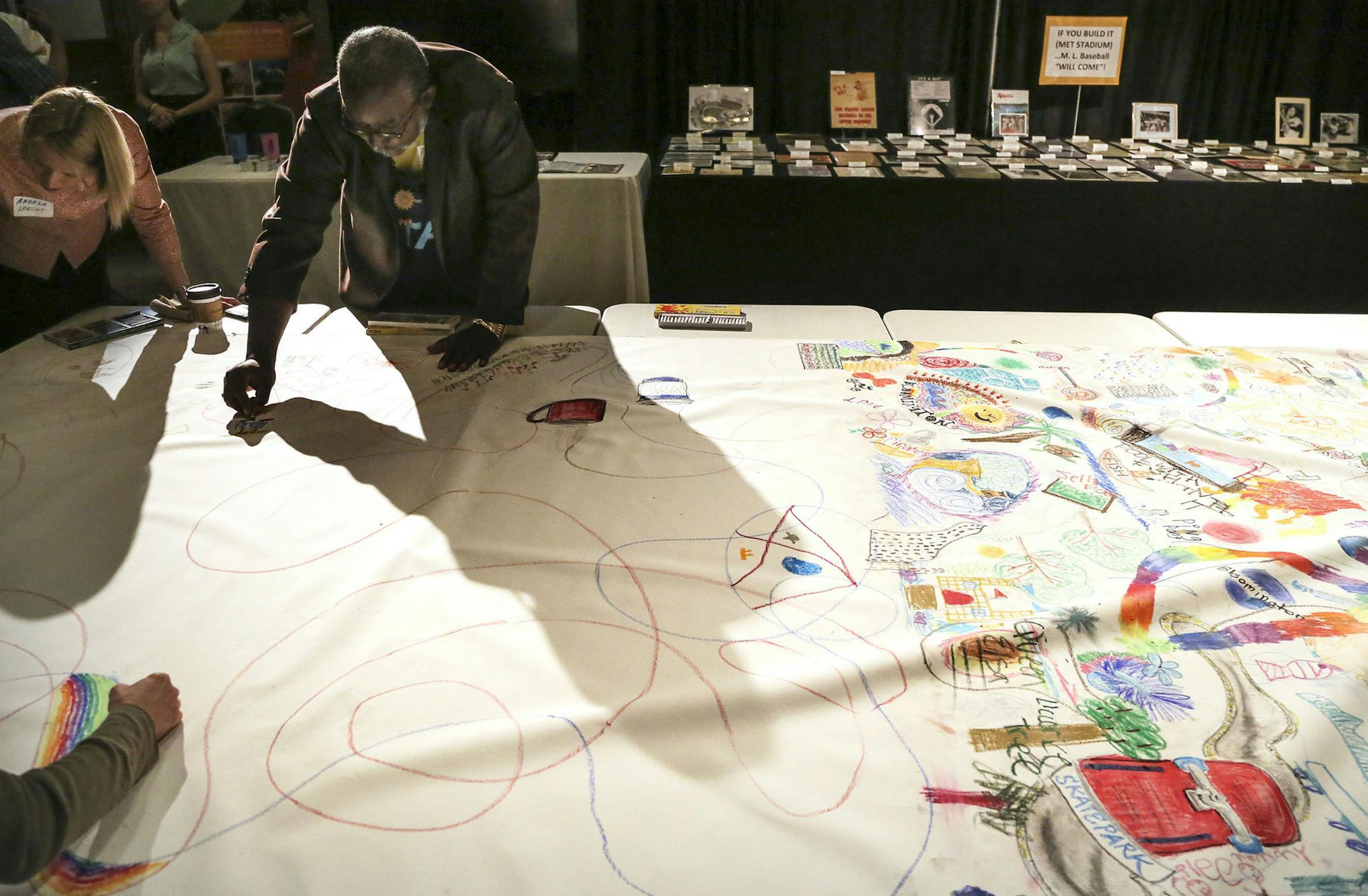 Community muralalist Ta-coumba Aiken, upper second from left, created this mural project with the aid of other community members and was seen working on it in the Great Room of the MOA, Thursday, June 12, 2014, in Bloomington, MN.] (DAVIDJOLES/STARTRIBUNE) djoles@startribune.com Bloomington is running a charrette -- a big community brain-storming session -- to make the arts a central part of the South Loop, the area of the city that is undergoing major redevelopment.**Ta-coumba Aiken,cq