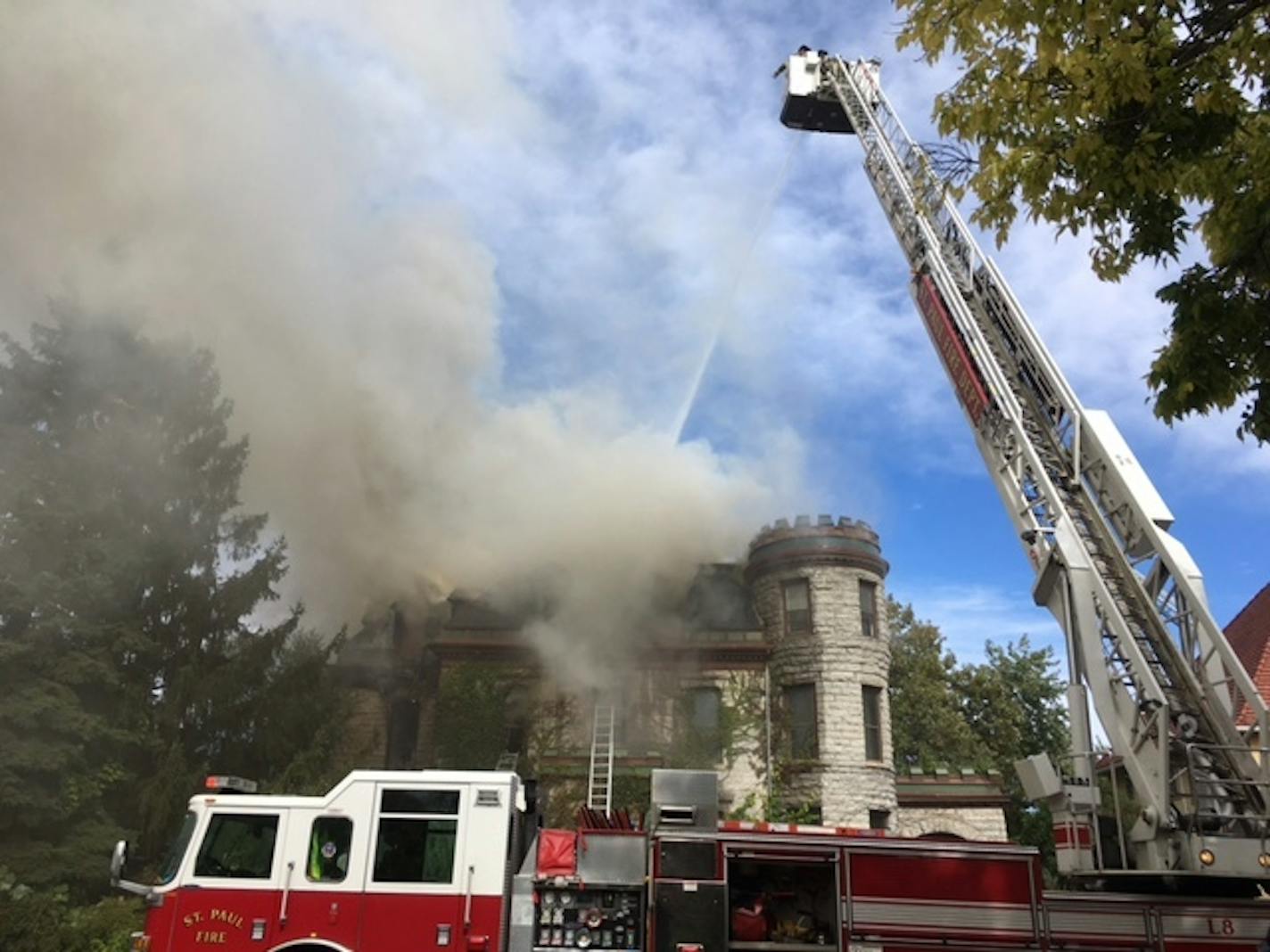 St. Paul firefighters worked to put out a large fire at a home near the St. Paul Cathedral Tuesday.