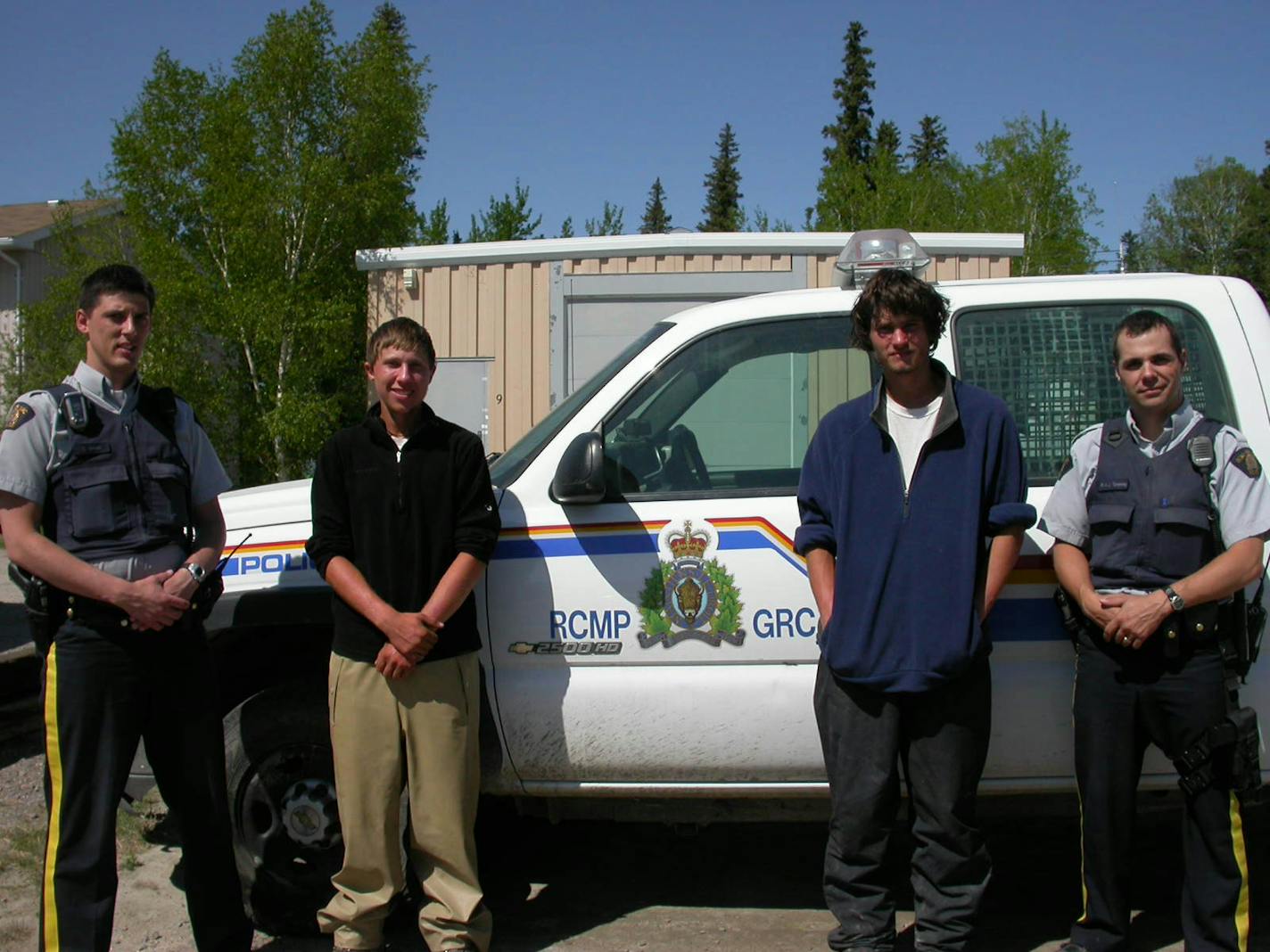 Colton Witte, left, and Sean Bloomfield posed with two Royal Canadian Mounties on Thursday in Norway House, a Cree reservation town in Manitoba. That day they actually had a restaurant breakfast — a stark change from their usual morning meal: moldy pizza. The two say they daydream about food a lot.