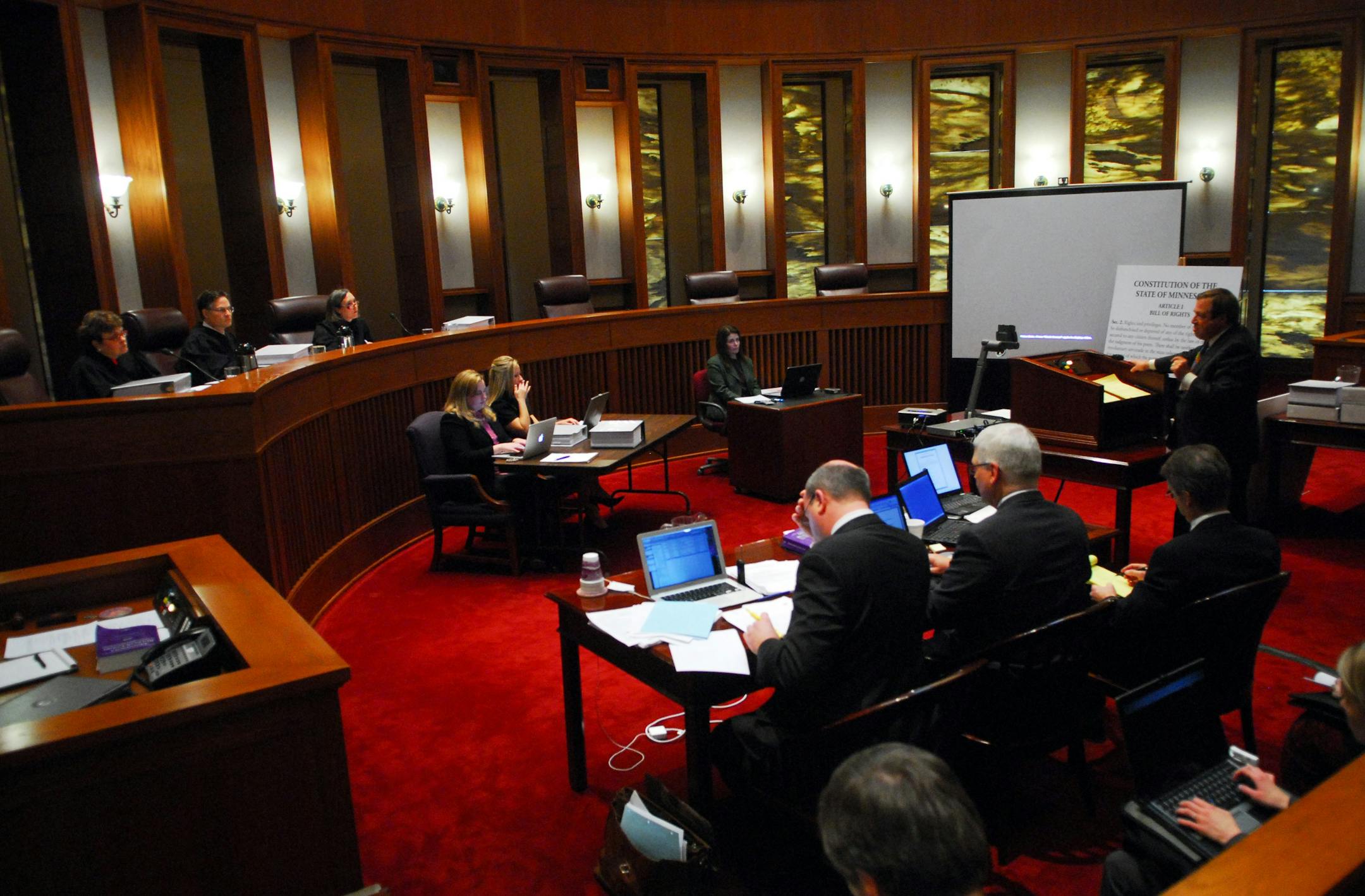 Norm Coleman's lawyer Joe Friedberg, at far right, delivered his opening statement Monday in the lawsuit over the recount of the U.S. Senate race. Al Franken's attorneys sat in the foreground. The three-judge panel is at left. Monday's action bogged down over whether judges could consider photocopied absentee ballots.