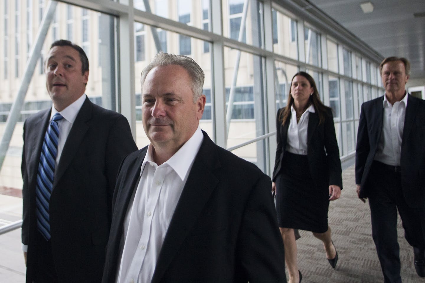 Former Starkey president Jerome C. Ruzicka and former Starkey human resources manager Larry W. Miller (far right) left the Federal Courthouse on Friday afternoon.