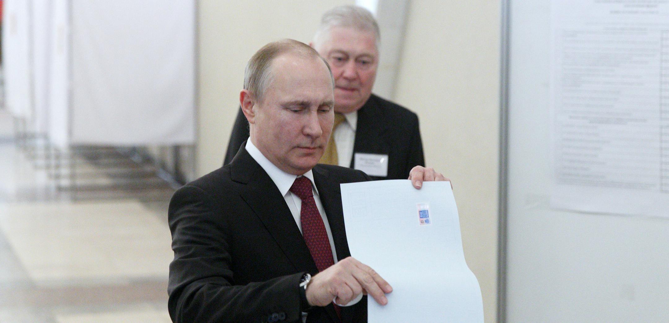 Incumbent Russian President Vladimir Putin, front, votes at a polling station in Moscow, Russia, on Sunday, March 18, 2018. The Central Election Commission said that with about a third of the ballots counted, more than 73.1 percent were for Putin. (Bai Xueqi/Xinhua/Sipa USA/TNS) ORG XMIT: 1226308
