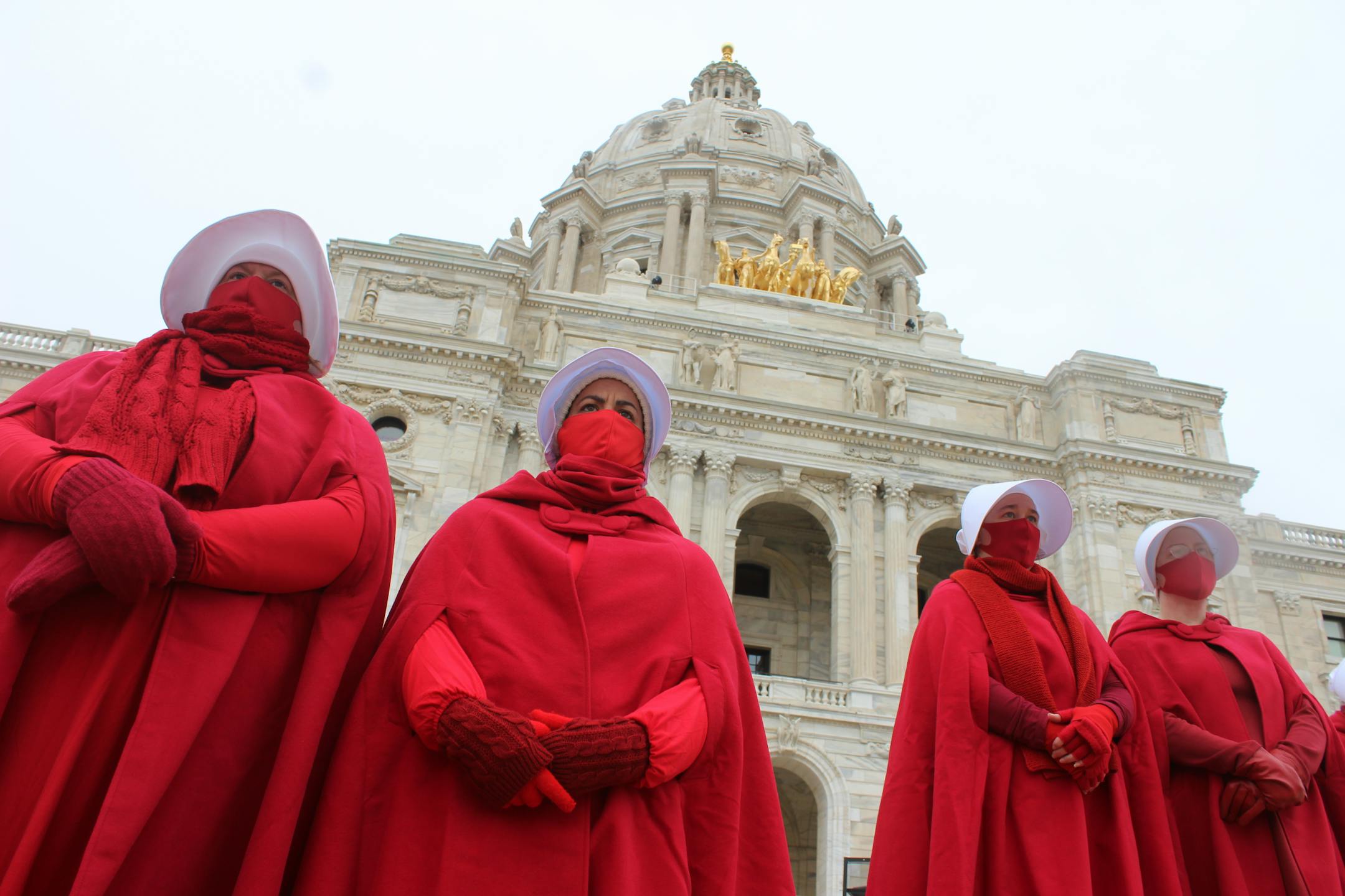 Members of the Handmaids of Minnesota stand on the capitol steps Nov. 8 to protest for a National Day of Action.