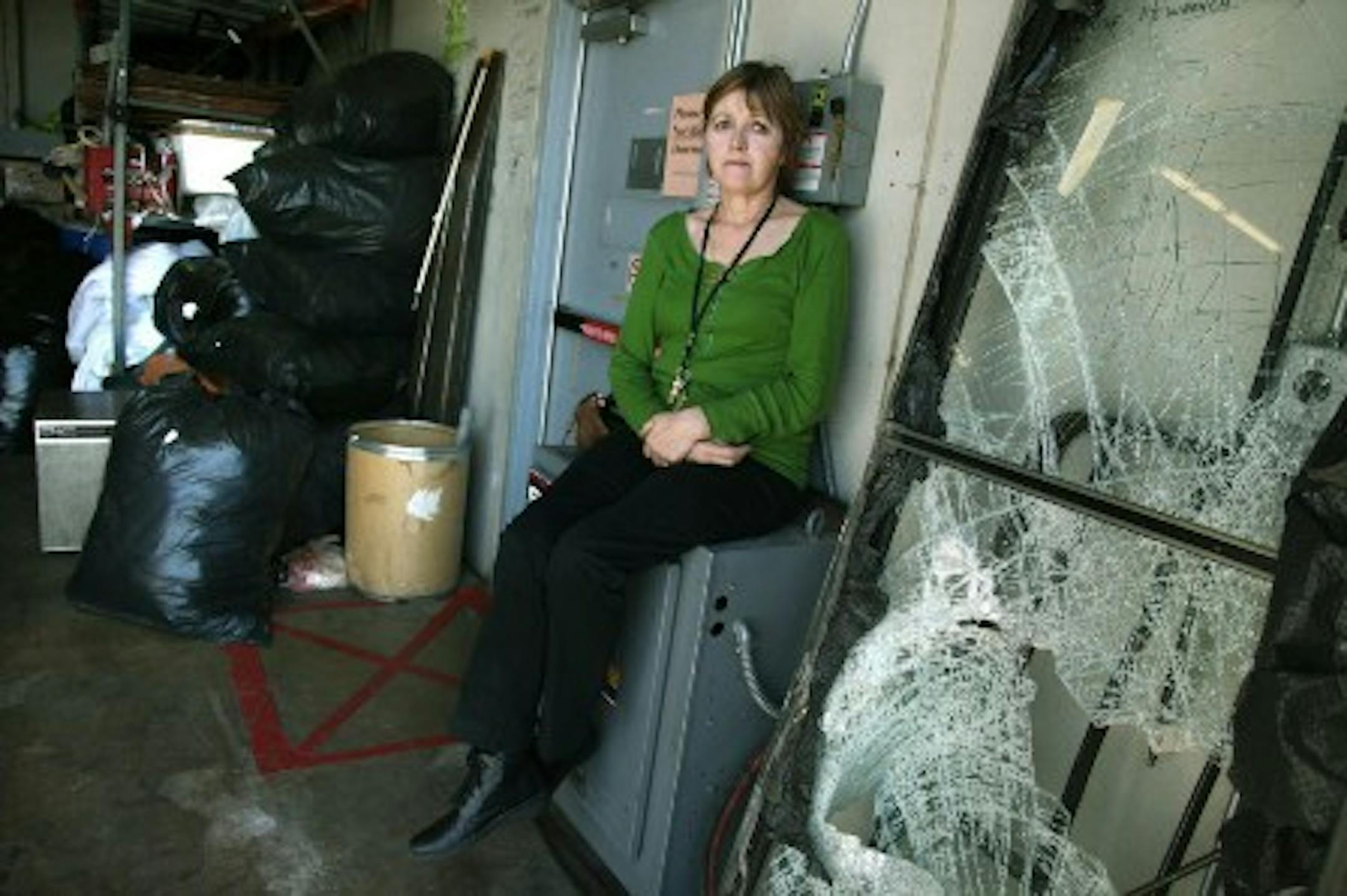 Patricia Gearin and the smashed door (Photo by Elizabeth Flores)