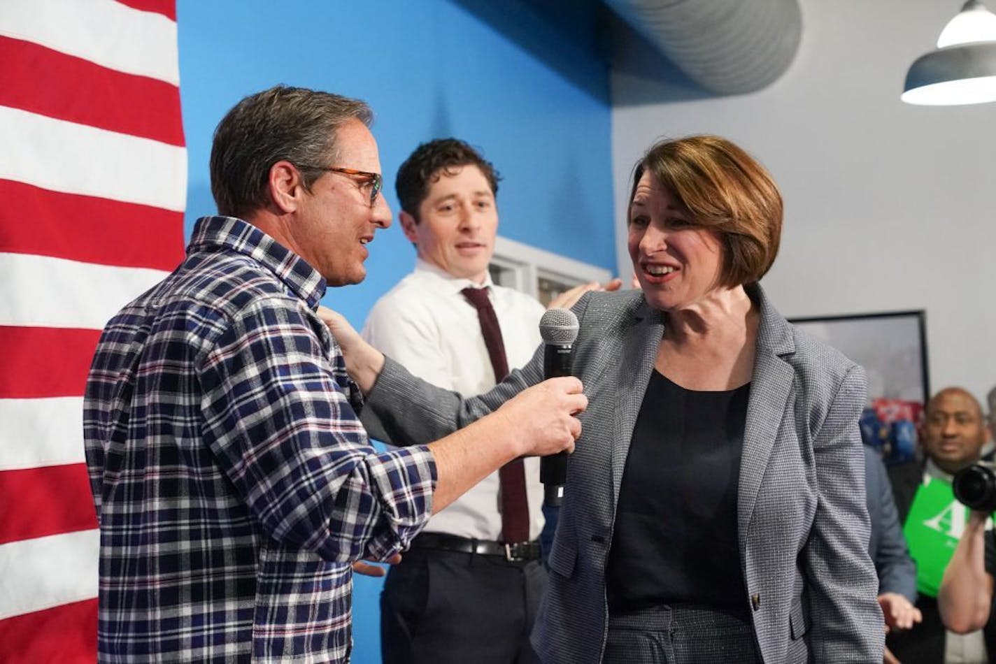 Amy Klobuchar thanked David Wellstone, son of the late Sen Paul Wellstone, for introducing her at the event and for his support. Behind them is Minneapolis Mayor Jacob Frey.