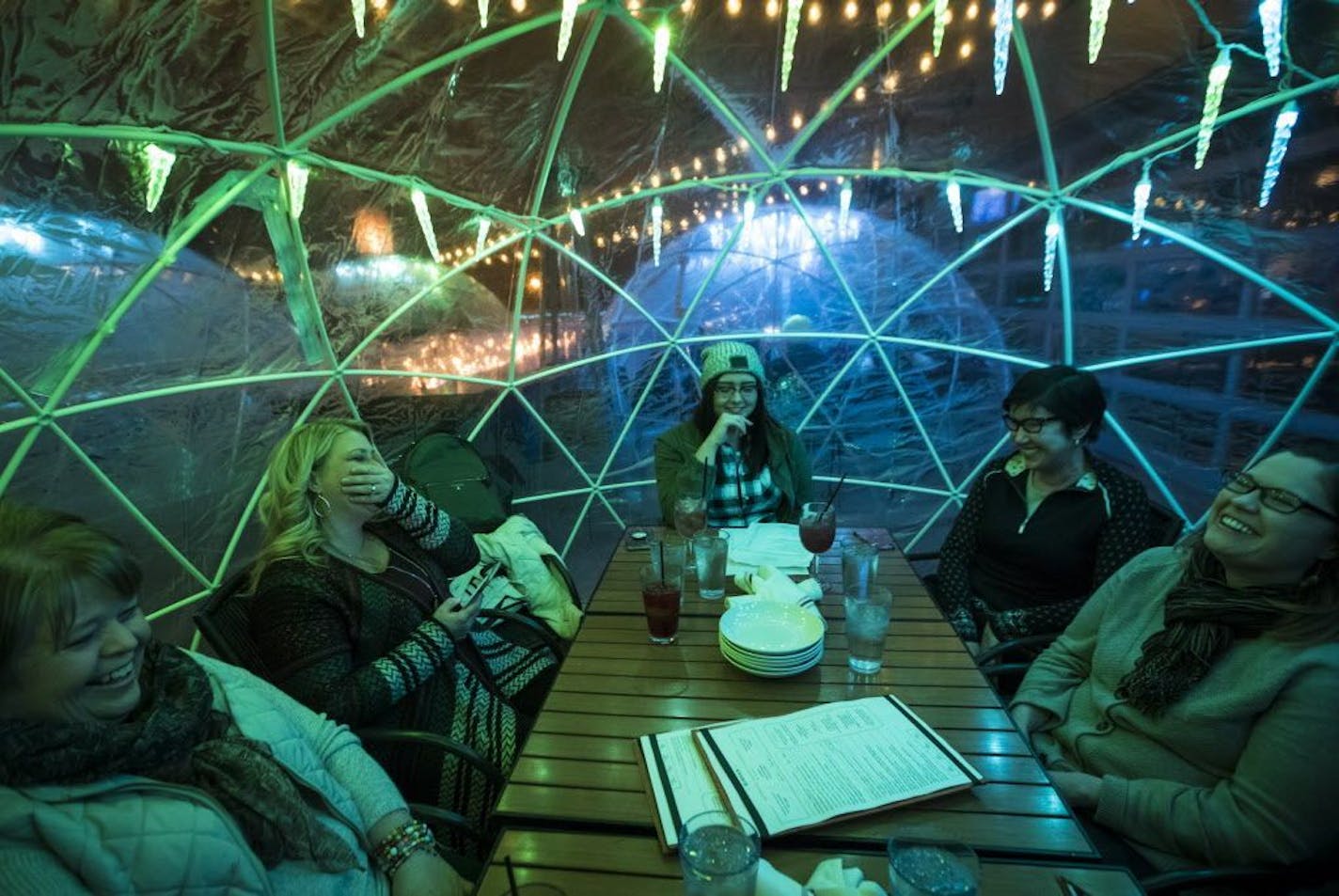 From the left; Mayo colleagues Brenda Luther, Michelle Luhman, Hannah Wright, Jean Fox, Stacy Weelborg and Ruth Grimm (not pictured) laughed during their team building meeting in an igloo on the rooftop at La Vetta on Wednesday, January 10, 2018, in Rochester, Minn.