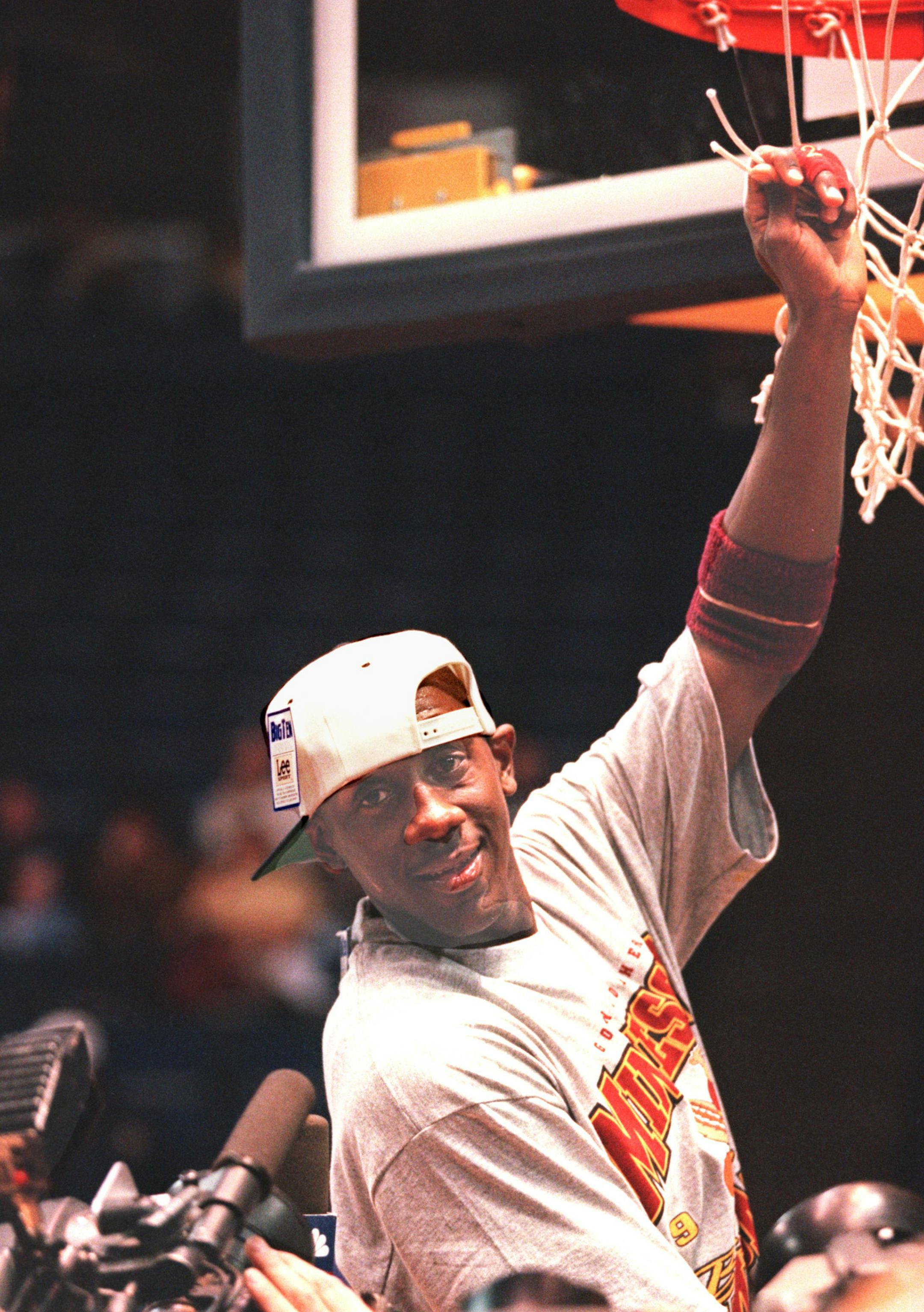 -- The Gophers Bobby Jackson wearing a Big Ten championship t-shirt and hat holds a piece of the net at Crisler Arena after defeating Michigan WEednesday night. ORG XMIT: MIN2014041318155734