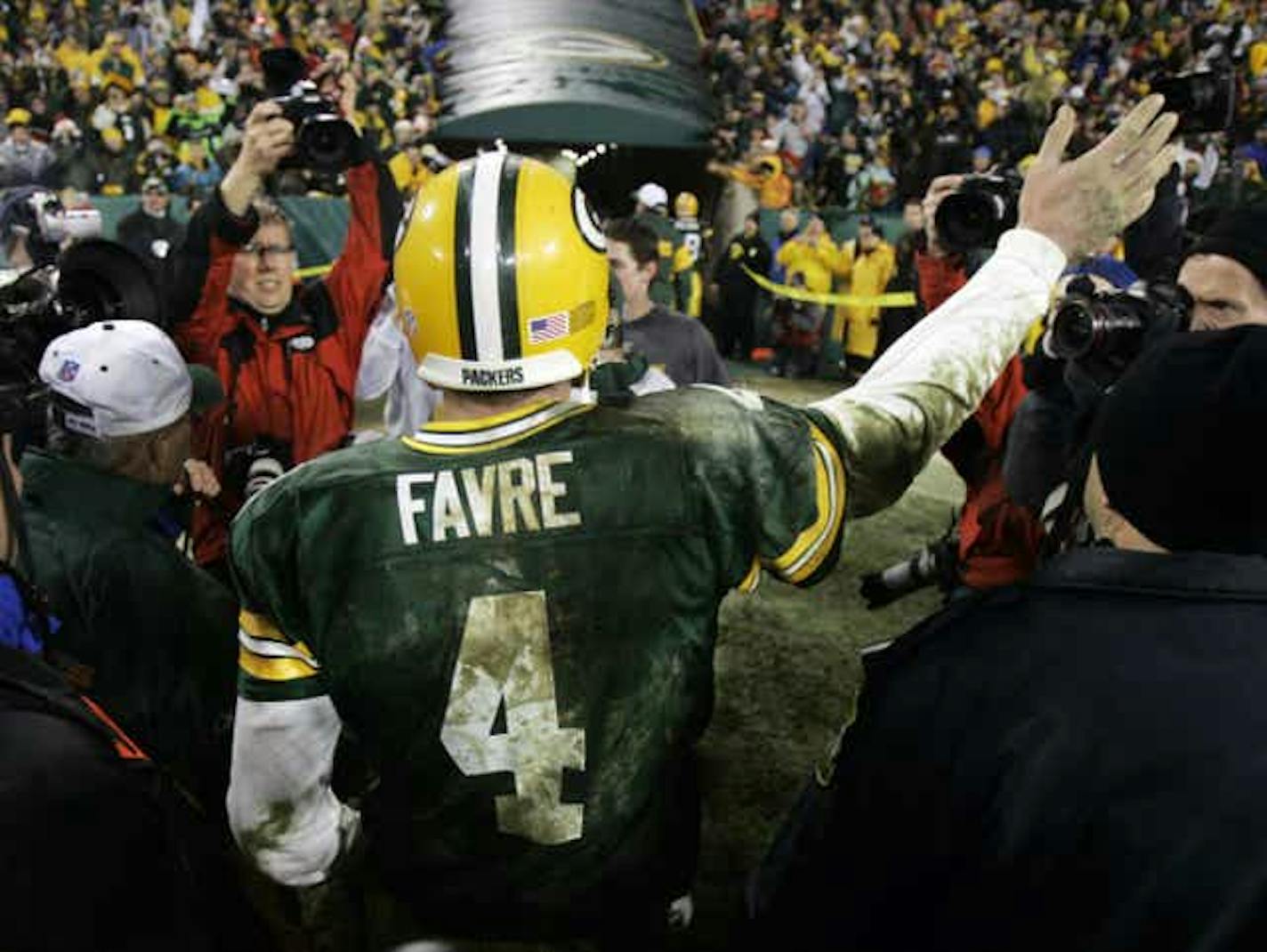 Brett Favre walks off the field after rallying the Packers past the Bengals.