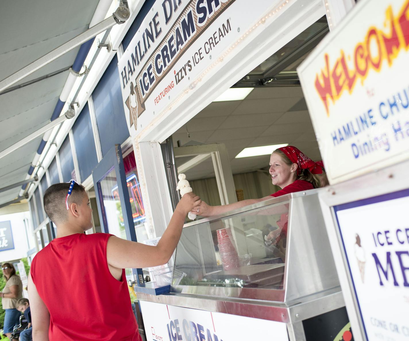 Paster Mariah Tollgaard, with the Hamline Church Dining Hall, served up three scoops of vanilla ice cream to Jesse Phillips, 12, of New Brighton, on Thursday at the Minnesota State Fair.