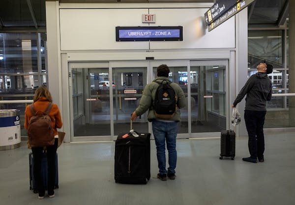 Travelers wait for rides at Terminal 1 of Minneapolis-St. Paul International Airport on March 21.
